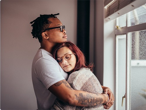 A man and a woman embrace each other